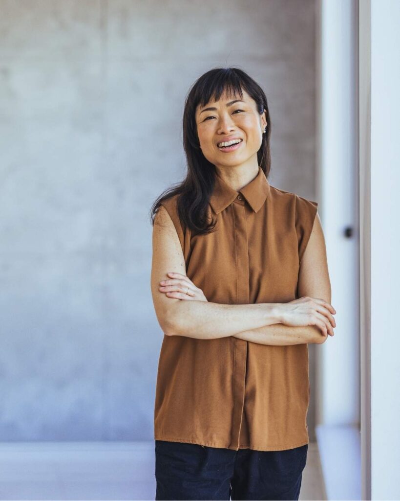 Smiling woman standing confidently, symbolising financial clarity and empowerment alongside Ikigai Wealth’s life-centred advice.
