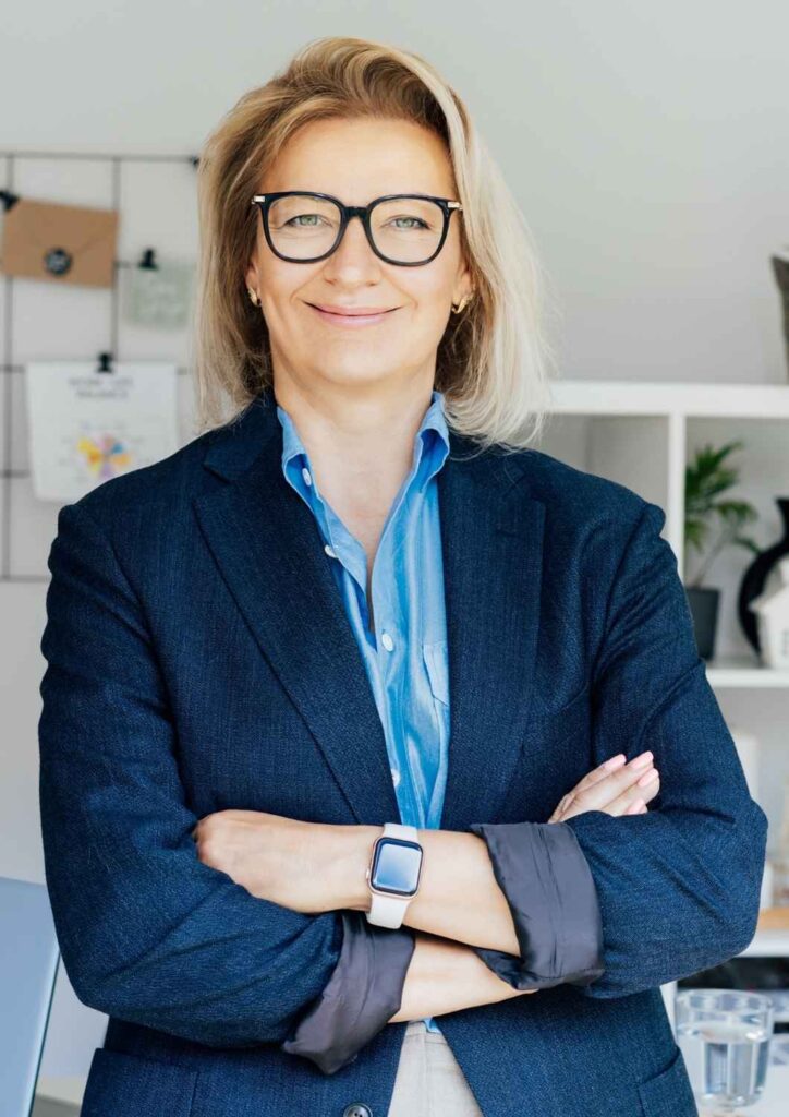 Professional woman smiling confidently, representing strategic wealth growth and purposeful investing.