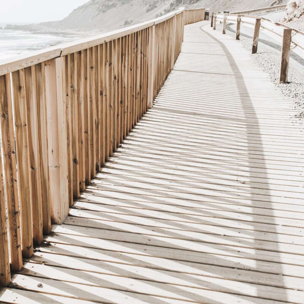 Wooden boardwalk leading forward, representing ongoing financial guidance and direction.