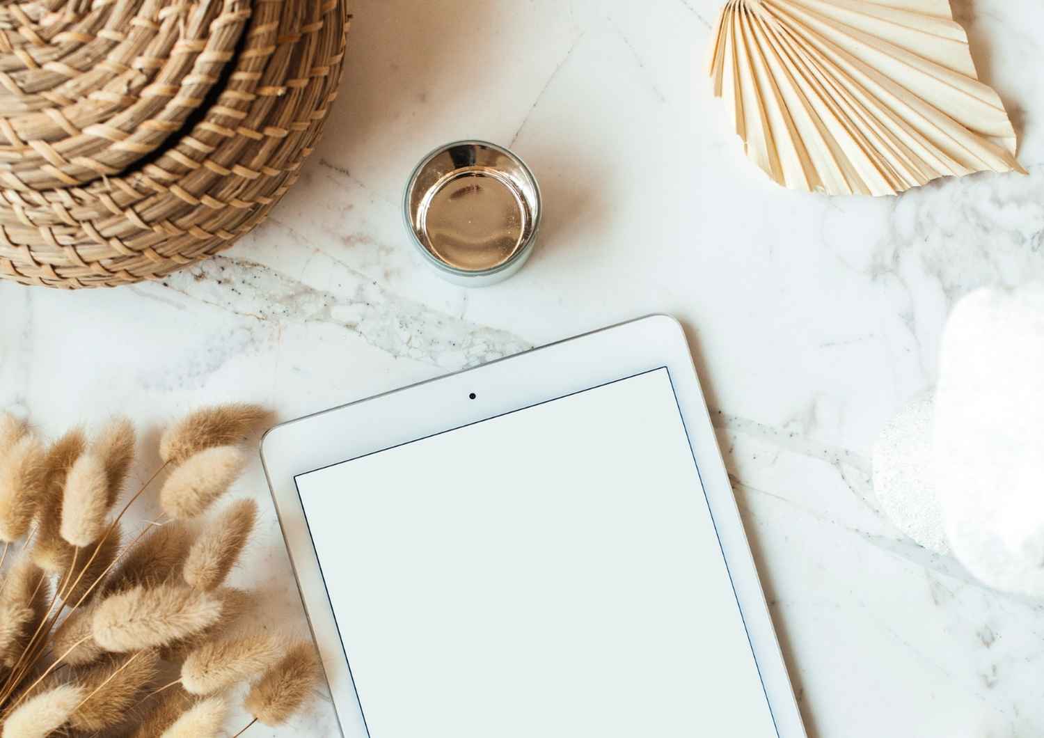 Neutral flat lay with tablet, cup, and woven textures, symbolising structure and organisation in business and personal finances.