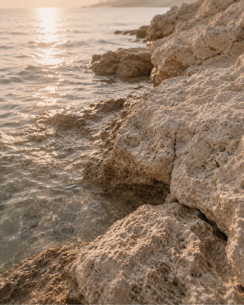 Rocky coastline at sunset, representing a steady and long-term approach to wealth planning.