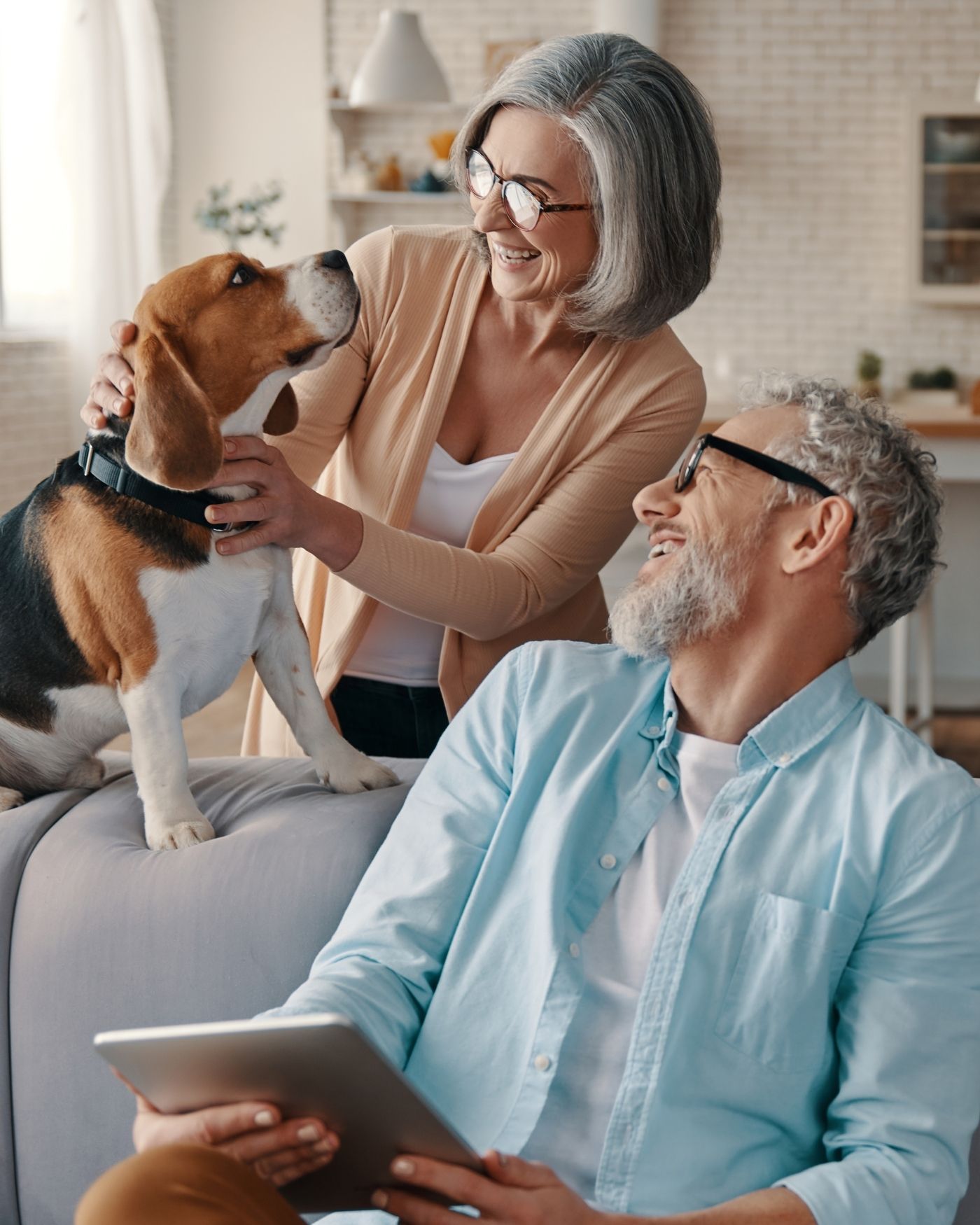Retired couple enjoying time at home with their dog, representing a confident and fulfilling retirement.